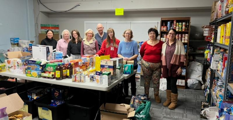 Volunteers at Ponds Food Pantry surrounded by food donations.