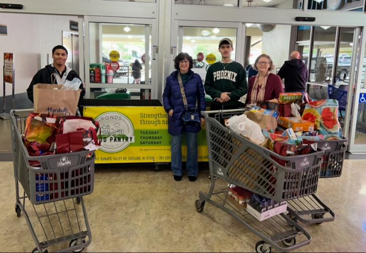 Ponds Food Pantry volunteers standing in Shoprite vestibule with shopping carts full of food donations